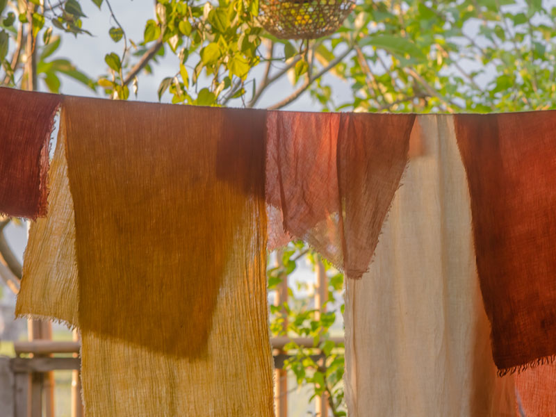 Hand dyed fabrics drying on a line