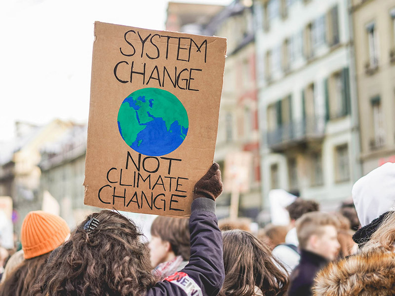 A young protestor holds up a sign at a climate rally.